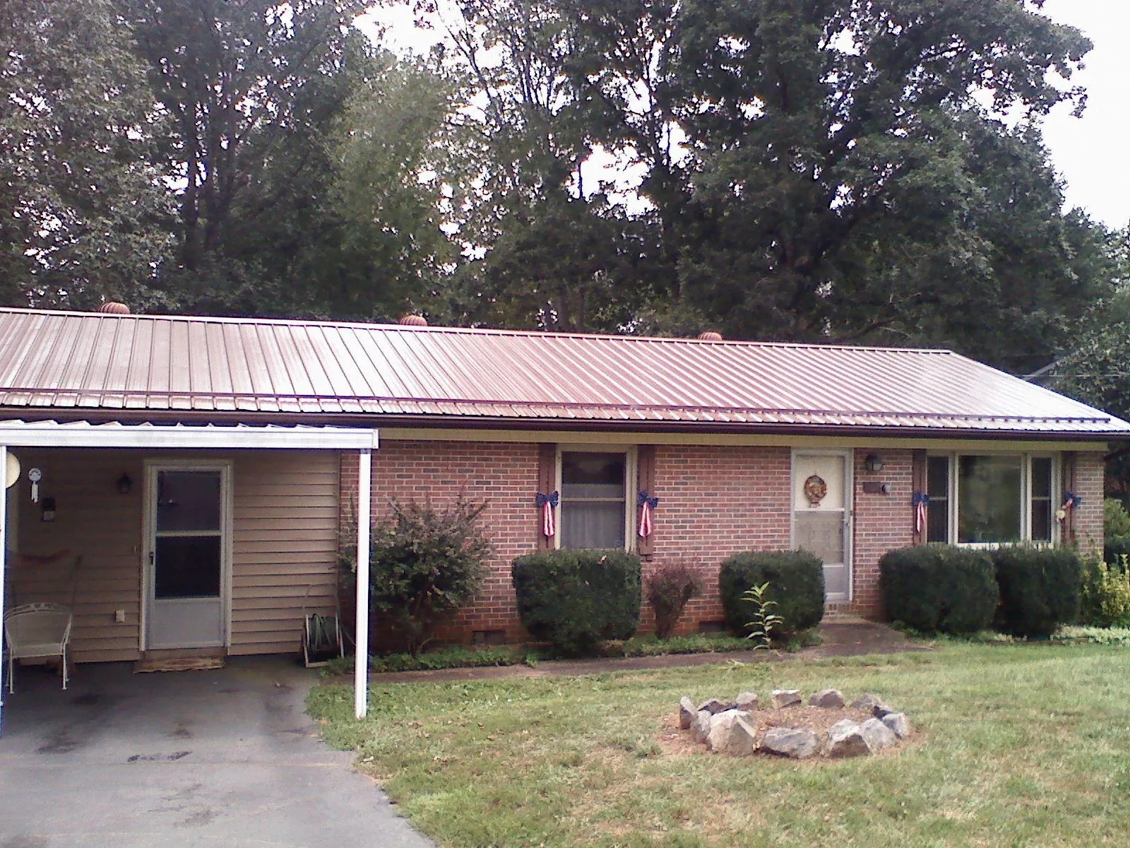 Bronze metal roof and carport on a brick ranch home — Roof Repair work by our crew in New Salem