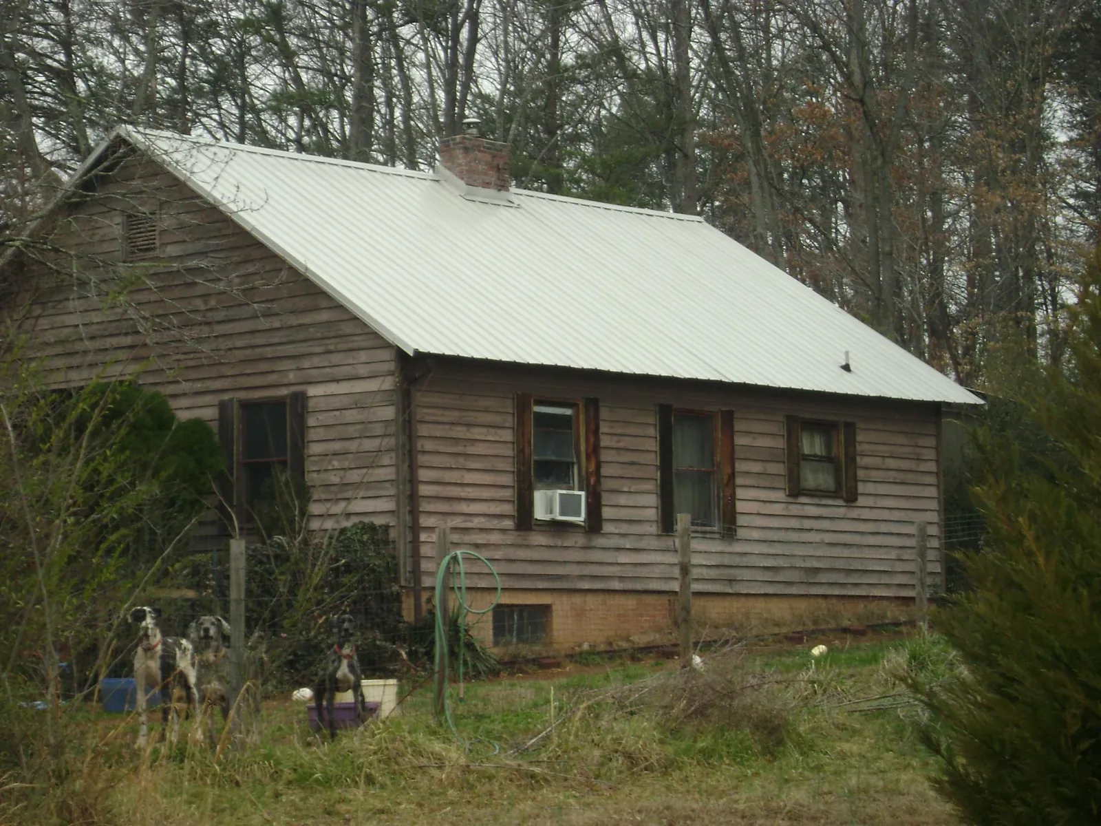 White metal roof on an old wood sided farmhouse, from a Metal Roof Installation job in New Salem